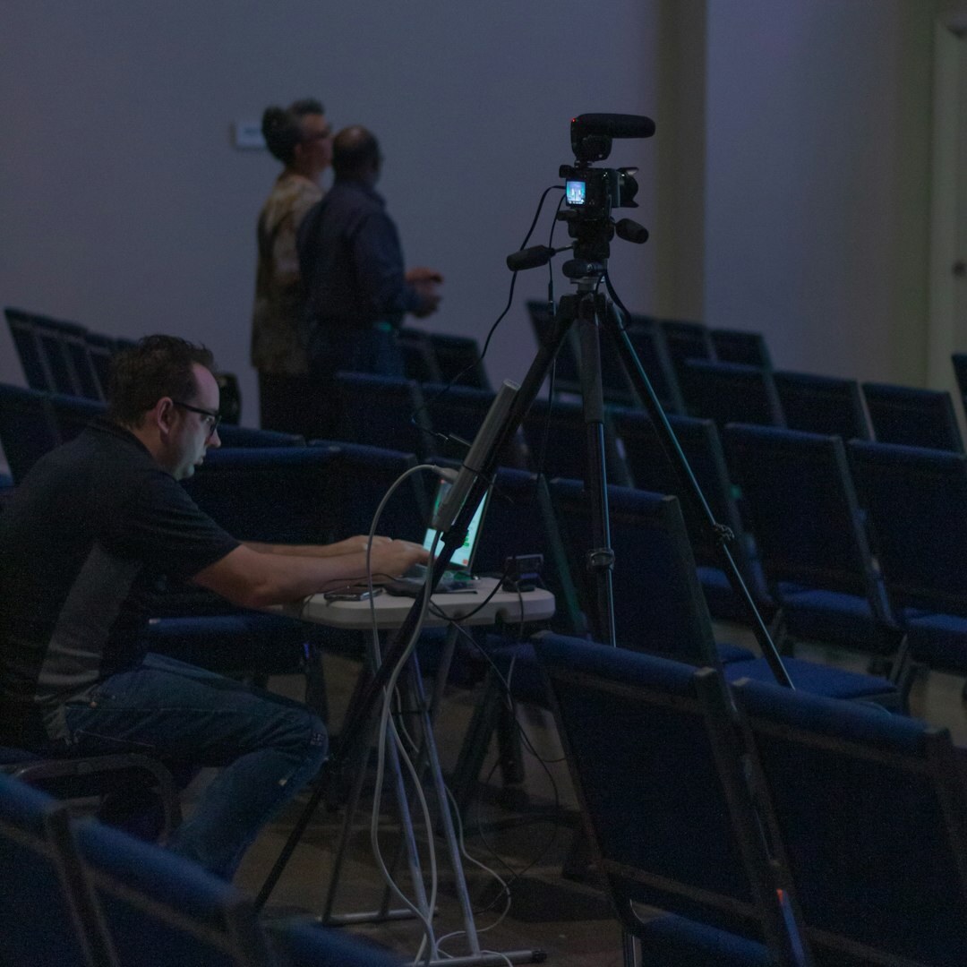 Small production team collaborating around monitors in a control room