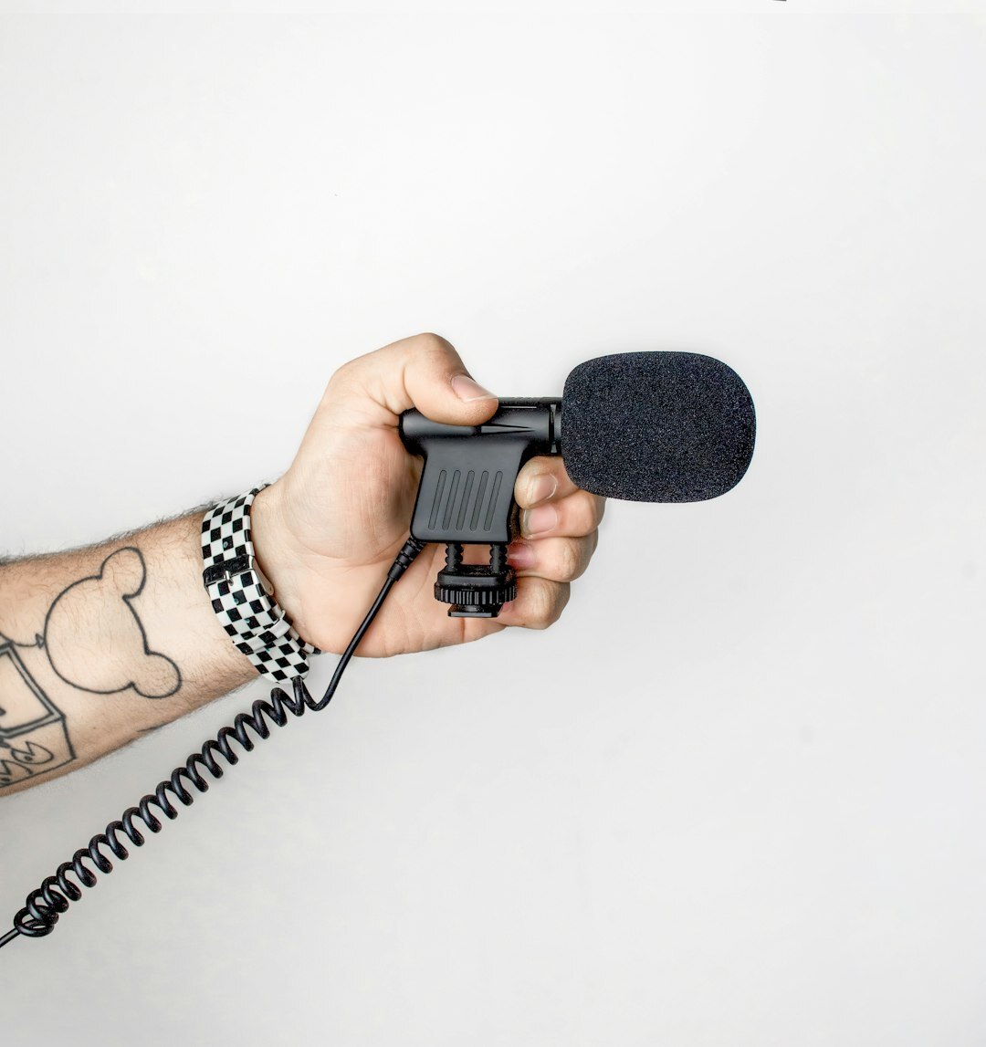 Journalist reporting live on camera outdoors with a microphone